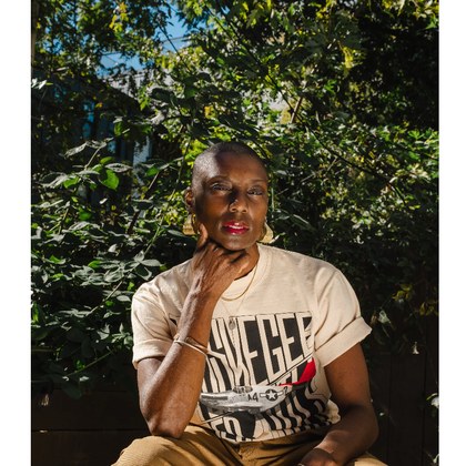 A woman wearing a Culture 12 Tuskegee Airmen tee
